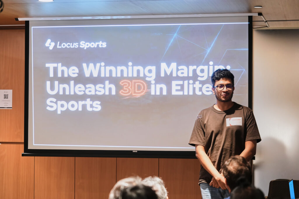 Speaker presenting Locus Sports slide titled The Winning Margin: Unleash 3D in Elite Sports.