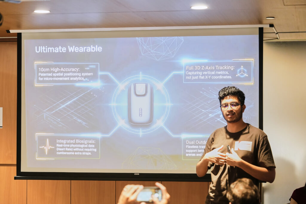 Presenter giving a tech presentation on an ultimate wearable device featuring 3D tracking and biosignals analytics.